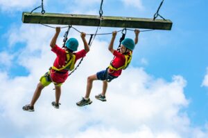 Camper enjoying a really big swing under expert supervision