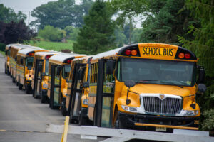 Campers boarding a supervised day camp bus